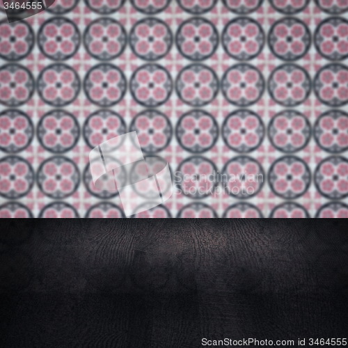 Image of Wood table top and blur vintage ceramic tile pattern wall
