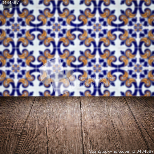 Image of Wood table top and blur vintage ceramic tile pattern wall