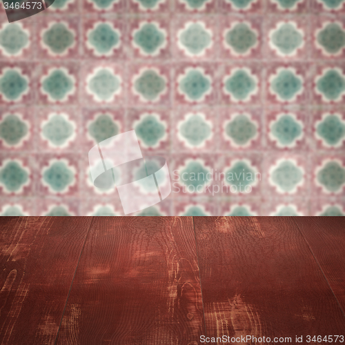 Image of Wood table top and blur vintage ceramic tile pattern wall