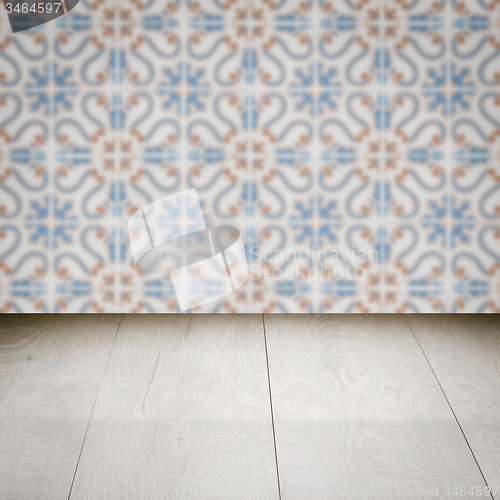 Image of Wood table top and blur vintage ceramic tile pattern wall