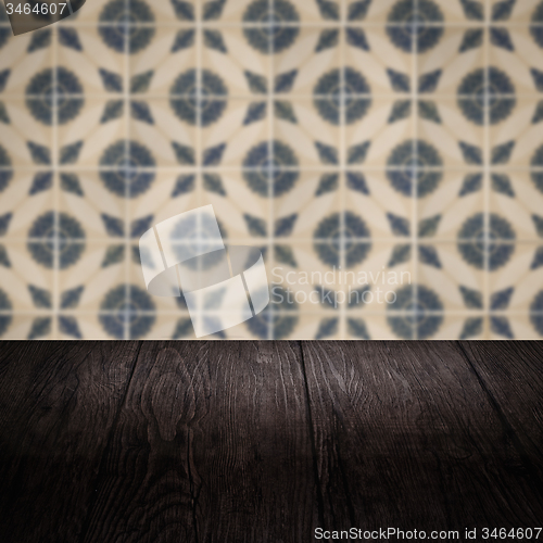Image of Wood table top and blur vintage ceramic tile pattern wall