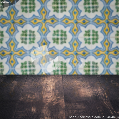 Image of Wood table top and blur vintage ceramic tile pattern wall
