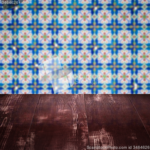 Image of Wood table top and blur vintage ceramic tile pattern wall