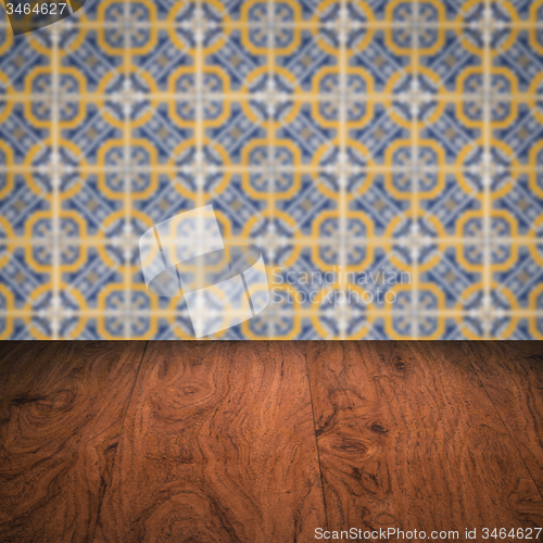 Image of Wood table top and blur vintage ceramic tile pattern wall