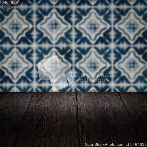 Image of Wood table top and blur vintage ceramic tile pattern wall