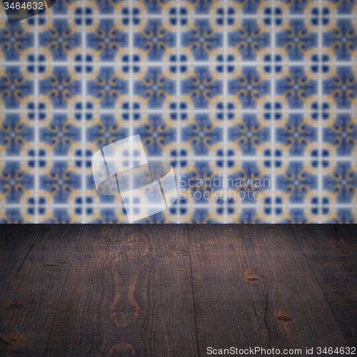 Image of Wood table top and blur vintage ceramic tile pattern wall