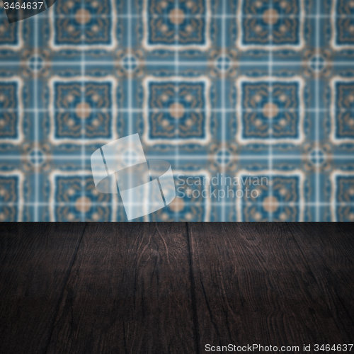 Image of Wood table top and blur vintage ceramic tile pattern wall