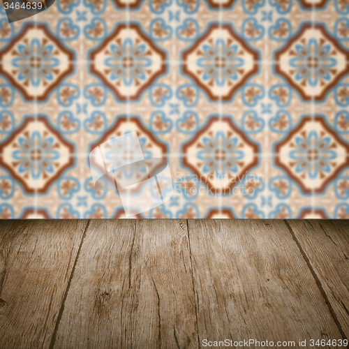 Image of Wood table top and blur vintage ceramic tile pattern wall