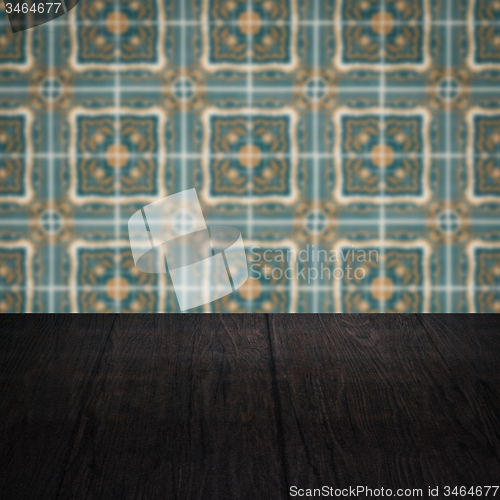 Image of Wood table top and blur vintage ceramic tile pattern wall