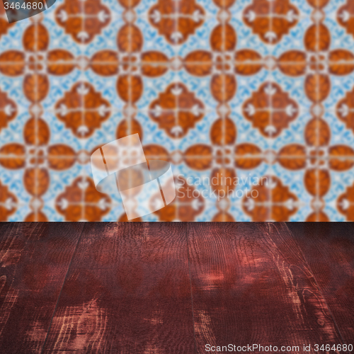 Image of Wood table top and blur vintage ceramic tile pattern wall