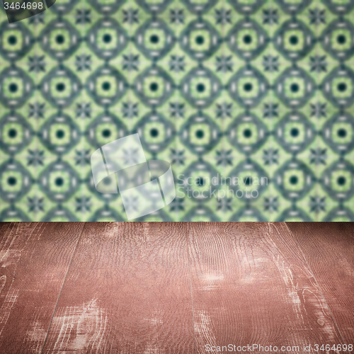 Image of Wood table top and blur vintage ceramic tile pattern wall