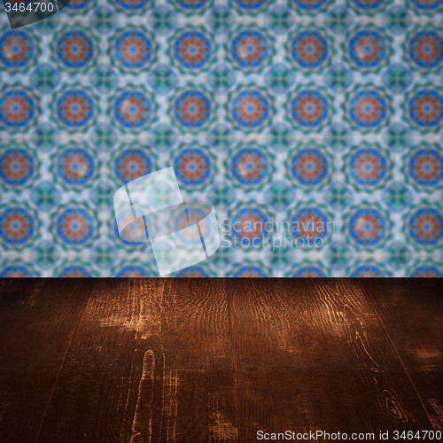 Image of Wood table top and blur vintage ceramic tile pattern wall