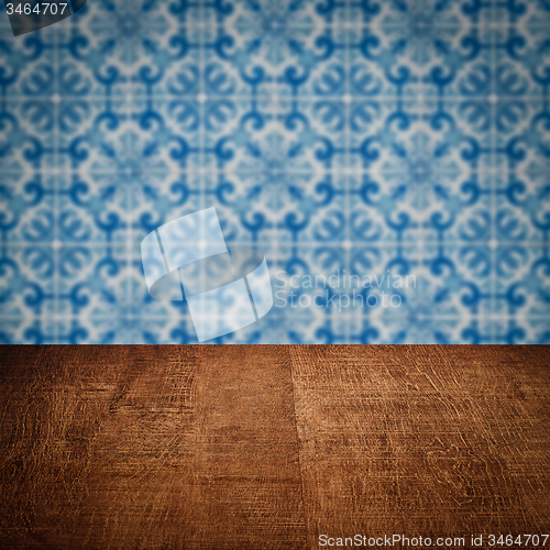Image of Wood table top and blur vintage ceramic tile pattern wall