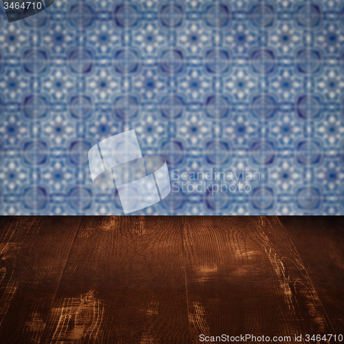 Image of Wood table top and blur vintage ceramic tile pattern wall