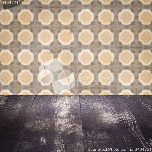 Image of Wood table top and blur vintage ceramic tile pattern wall