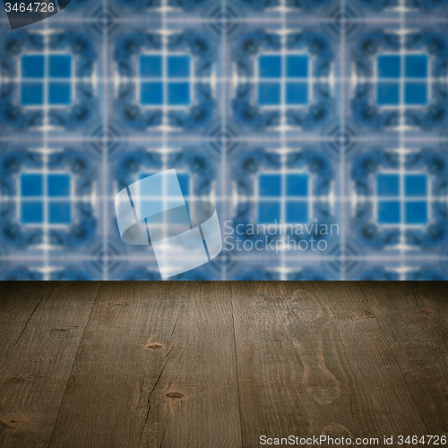 Image of Wood table top and blur vintage ceramic tile pattern wall