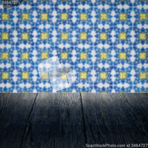 Image of Wood table top and blur vintage ceramic tile pattern wall