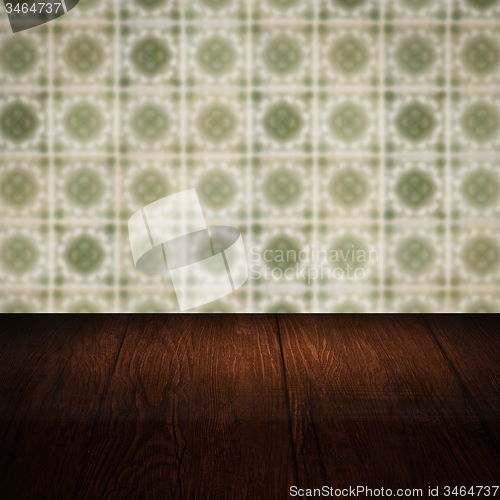 Image of Wood table top and blur vintage ceramic tile pattern wall