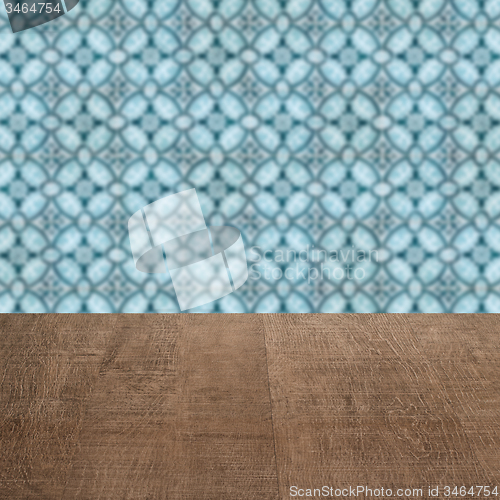 Image of Wood table top and blur vintage ceramic tile pattern wall