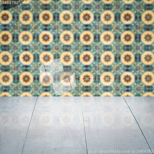 Image of Wood table top and blur vintage ceramic tile pattern wall