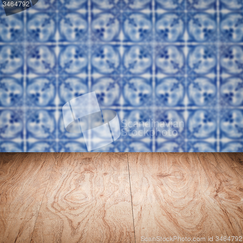 Image of Wood table top and blur vintage ceramic tile pattern wall