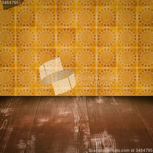 Image of Wood table top and blur vintage ceramic tile pattern wall