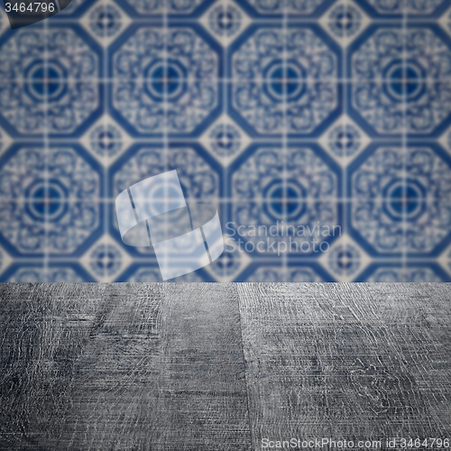 Image of Wood table top and blur vintage ceramic tile pattern wall