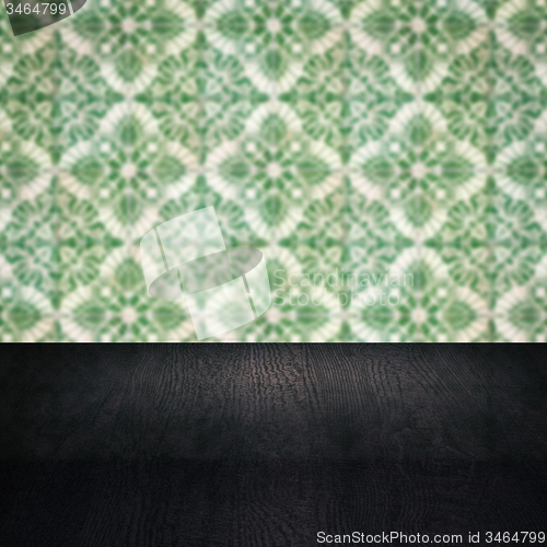 Image of Wood table top and blur vintage ceramic tile pattern wall