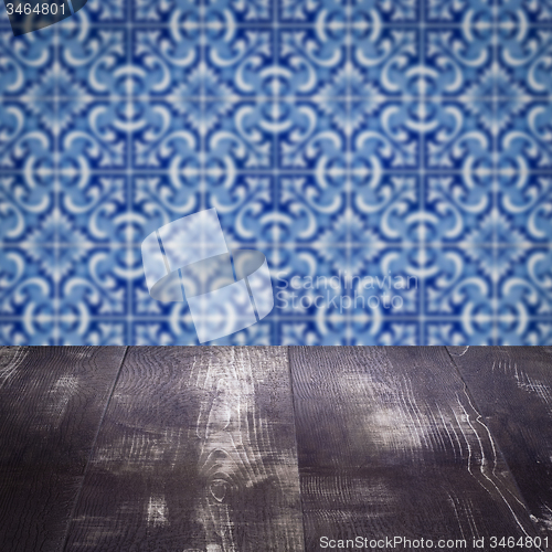 Image of Wood table top and blur vintage ceramic tile pattern wall