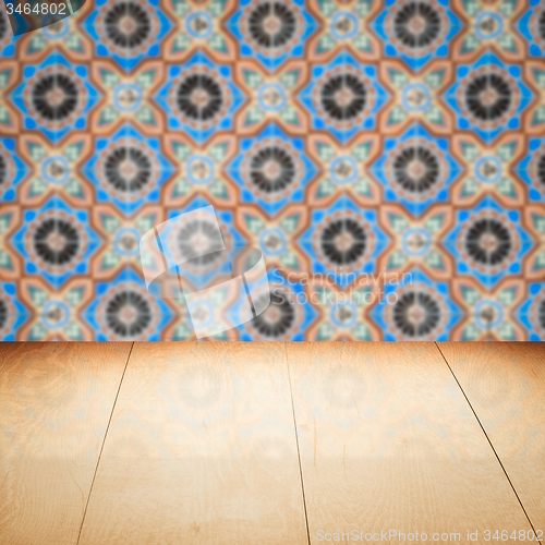 Image of Wood table top and blur vintage ceramic tile pattern wall