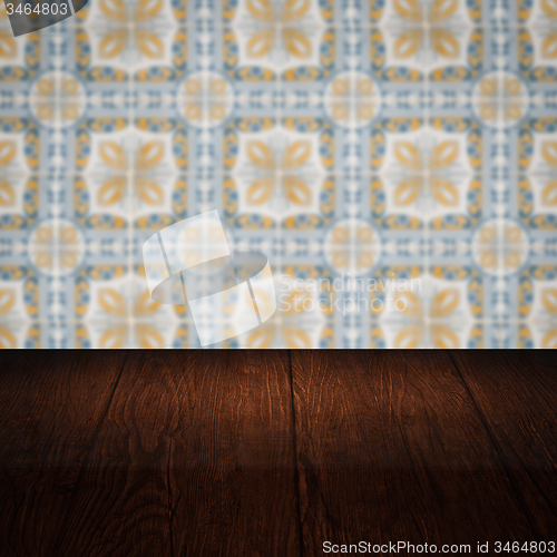 Image of Wood table top and blur vintage ceramic tile pattern wall