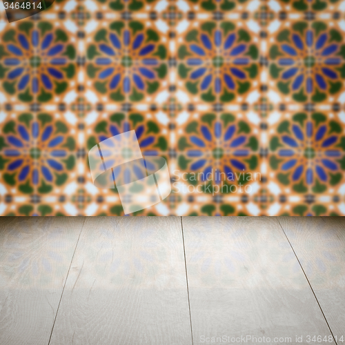 Image of Wood table top and blur vintage ceramic tile pattern wall