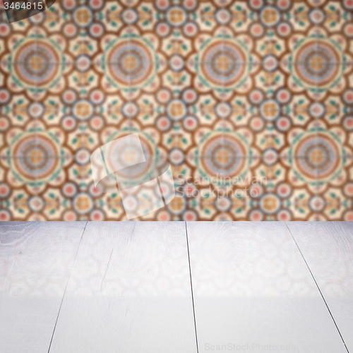 Image of Wood table top and blur vintage ceramic tile pattern wall