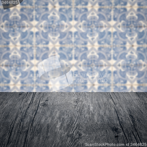 Image of Wood table top and blur vintage ceramic tile pattern wall