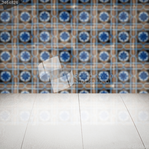 Image of Wood table top and blur vintage ceramic tile pattern wall