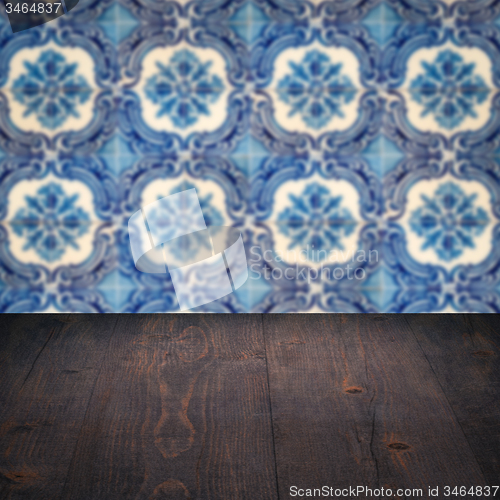 Image of Wood table top and blur vintage ceramic tile pattern wall