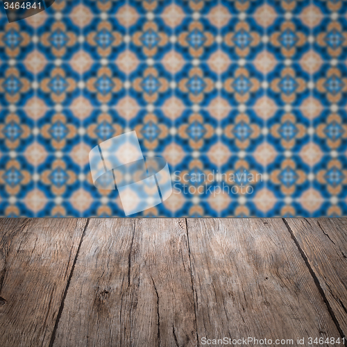 Image of Wood table top and blur vintage ceramic tile pattern wall