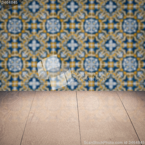 Image of Wood table top and blur vintage ceramic tile pattern wall