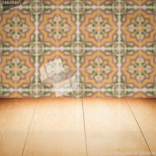 Image of Wood table top and blur vintage ceramic tile pattern wall