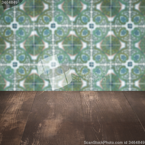 Image of Wood table top and blur vintage ceramic tile pattern wall