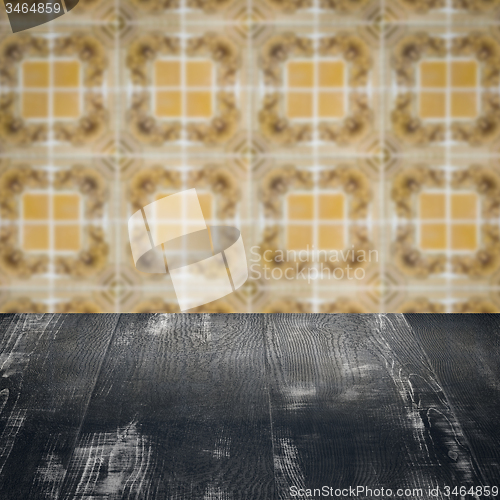 Image of Wood table top and blur vintage ceramic tile pattern wall