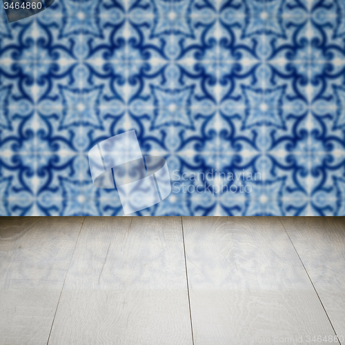 Image of Wood table top and blur vintage ceramic tile pattern wall