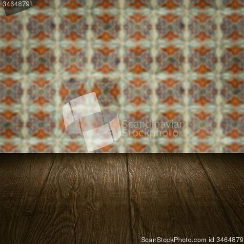 Image of Wood table top and blur vintage ceramic tile pattern wall
