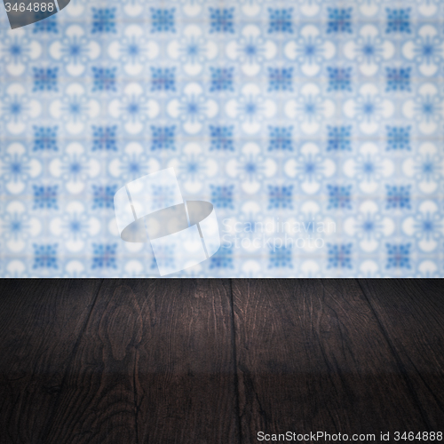 Image of Wood table top and blur vintage ceramic tile pattern wall