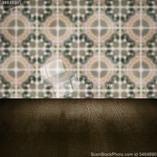 Image of Wood table top and blur vintage ceramic tile pattern wall