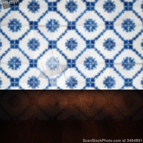 Image of Wood table top and blur vintage ceramic tile pattern wall