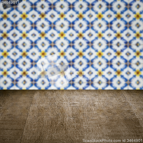 Image of Wood table top and blur vintage ceramic tile pattern wall