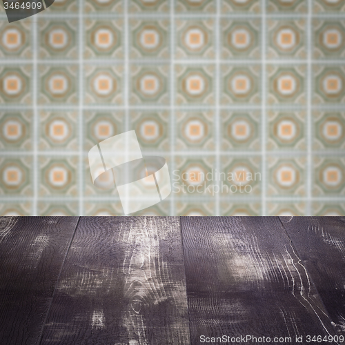 Image of Wood table top and blur vintage ceramic tile pattern wall