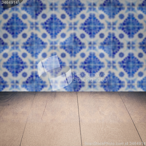 Image of Wood table top and blur vintage ceramic tile pattern wall