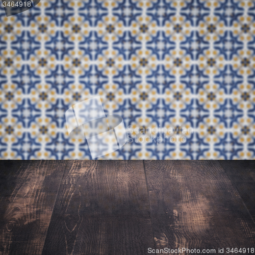 Image of Wood table top and blur vintage ceramic tile pattern wall